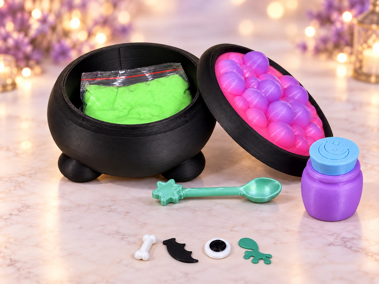 Witches Brew kit: open cauldron with green sand, rainbow bubble lid, potion bottle, Spell Spoon, bone, bat wing, eye, and frog-leg piece.